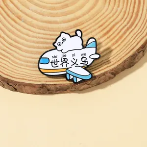 Macro detail of cartoon cat enamel pin on wooden base featuring airplane design