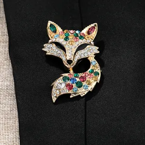 Close-up of sparkling fox brooch with colorful rhinestones on a dark fabric