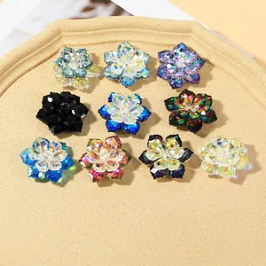 Macro shot of assorted crystal flower cufflinks in multiple colors on a stone tray