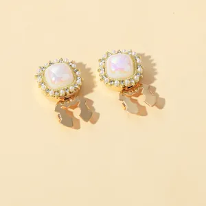 Detailed view of vintage gold collar clips with iridescent stones and small pearls