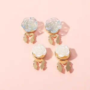 Detail of elegant rose-shaped metal scarf clips in iridescent and pearl finishes