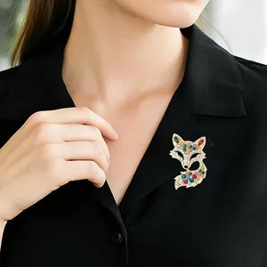Sparkling fox brooch with colorful rhinestones on a gold setting for elegant suit styling