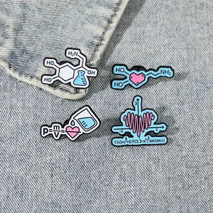 Close-up of math and science enamel pins with density formula on denim fabric