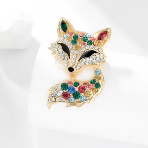 Detailed macro view of gold-tone fox brooch with colorful rhinestone pave settings