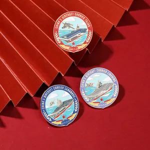 Detailed view of three Chinese aircraft carrier enamel pins on a red background