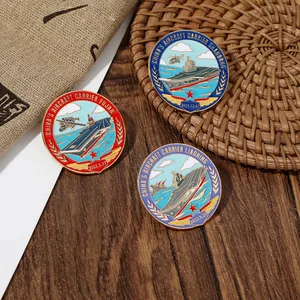 Detailed set of three Chinese aircraft carrier badges on a rustic wooden background
