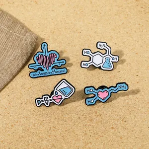 Detailed view of four science-themed enamel pins with formulas on a textured surface