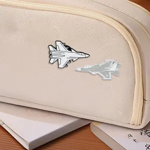 Fighter jet enamel pins in grey and white colors pinned on an off-white canvas bag