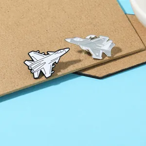 Detail of metal fighter jet enamel pins showing butterfly clutch backs and alloy texture