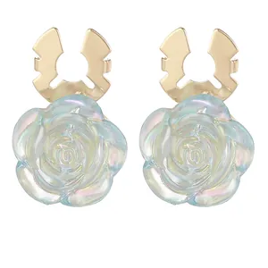 Elegant rose flower earrings with iridescent petals and gold metal finish on white background