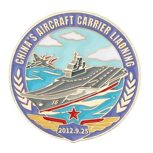 Round gold enamel pin featuring China's Liaoning aircraft carrier and fighter jet design