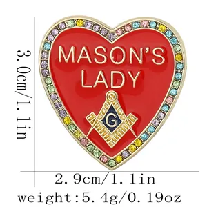 Macro shot of Mason's Lady heart enamel brooch with colorful rhinestones and gold emblem