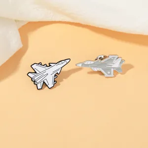 Detailed close-up of aviation fighter jet metal pins with enamel finish and butterfly clasps