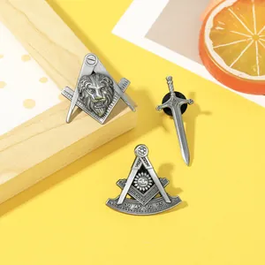 Three-piece Masonic pin set with lion, sword, and compass symbols in antique silver finish