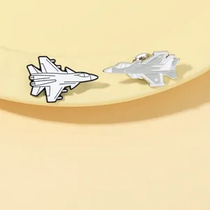 Detail of aircraft enamel pins in white and gray finish with silver metallic lines