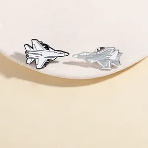 Detail shot of black and white enamel fighter jet lapel pins with metal butterfly clutches