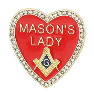 Close-up of heart-shaped Mason's Lady enamel brooch with crystals and gold plating