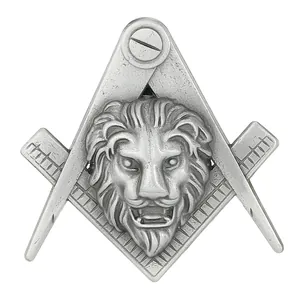 Macro detail of vintage silver lion head brooch with Freemasonry symbol and engraving