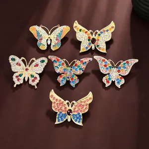 Detail showing high-end butterfly brooches with colorful rhinestones and gold alloy base