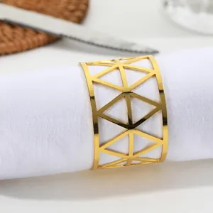 Detailed view of golden triangular mesh napkin ring on a white rolled cloth napkin
