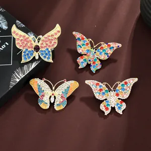 Macro detail of alloy butterfly brooches with colorful rhinestones and enamel inlay
