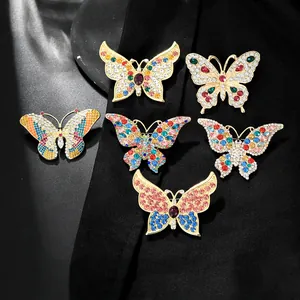 Macro detail of alloy butterfly brooches with colorful rhinestones and gold plating