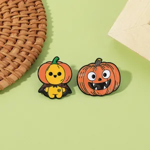 Detail of Halloween enamel pins showing a cartoon figure and a classic pumpkin lantern