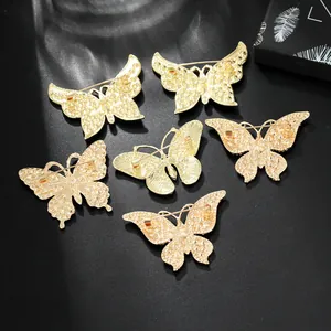 Set of 6 high-quality gold butterfly brooches with back safety pin closure on black background