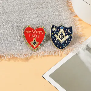 Detailed close-up of Freemason enamel brooches featuring rhinestone borders and emblems