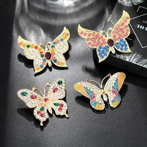 Macro detail of alloy butterfly brooches with colorful rhinestones on black leather