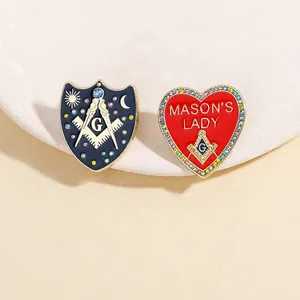 Close-up of Masonic shield and Mason's Lady heart pins with rhinestones and enamel