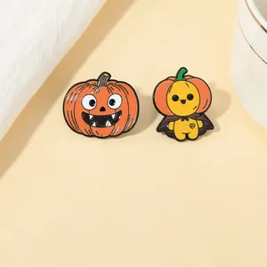 Detail of Halloween enamel pins showing a spooky pumpkin and a cute ghost in orange and yellow