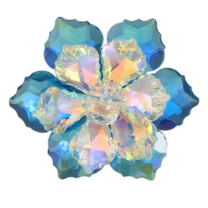 Macro shot of teal and AB crystal flower button with sparkling rhinestone center detail