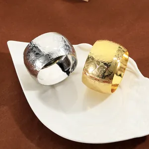Embossed floral metal napkin rings in gold and silver finish for elegant dining decor
