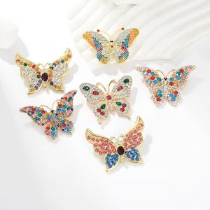 Macro detail of alloy butterfly brooches with multi-colored crystals and gold finish