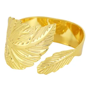 Elegant gold leaf napkin ring with polished metal texture on a clean white background