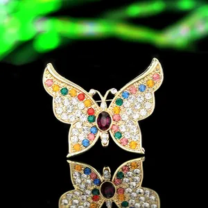 Detailed macro view of an elegant butterfly brooch with colorful rhinestones on a mirror
