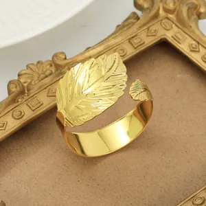 Elegant gold leaf napkin ring with polished mirror finish and detailed vein textures