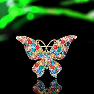 Detail view of a luxury alloy butterfly brooch with vibrant multicolor rhinestones and gold base