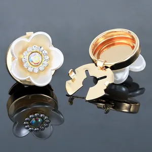 Close-up of pearl camellia cufflink with intricate floral petal details and crystals