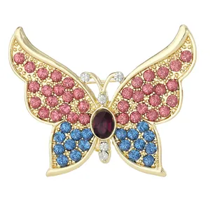 Elegant gold butterfly brooch with pink and blue rhinestones and a purple center stone