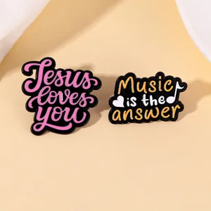 Enamel alloy brooches featuring Jesus Loves You and Music Is The Answer designs