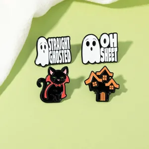 Detail view of four Halloween enamel pins featuring ghosts, black cat, and haunted house