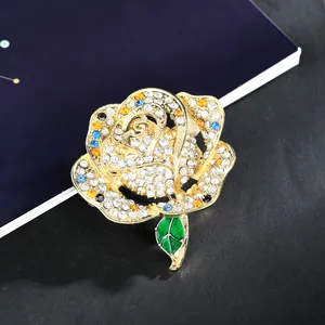 Elegant rose brooch with colorful rhinestones and green enamel leaf on gold metal