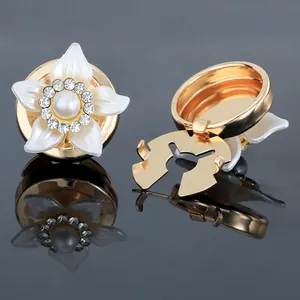 Macro shot of camellia cufflinks with white pearls and sparkling crystal details