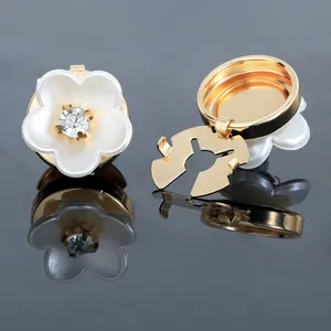 Detailed view of camellia cufflinks featuring white petals and a sparkling center crystal