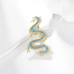 Gothic punk gold-plated dragon brooch with sparkling blue and white rhinestones