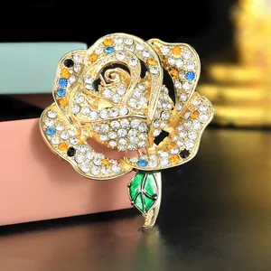 Elegant rose brooch with colorful rhinestones and green enamel leaf for sweaters
