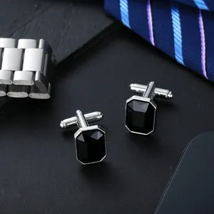 Classic men's silver square cufflinks with black gemstone on a premium tie background