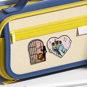 Fairy tale enamel pins with knight cage and crown heart shapes on a canvas bag